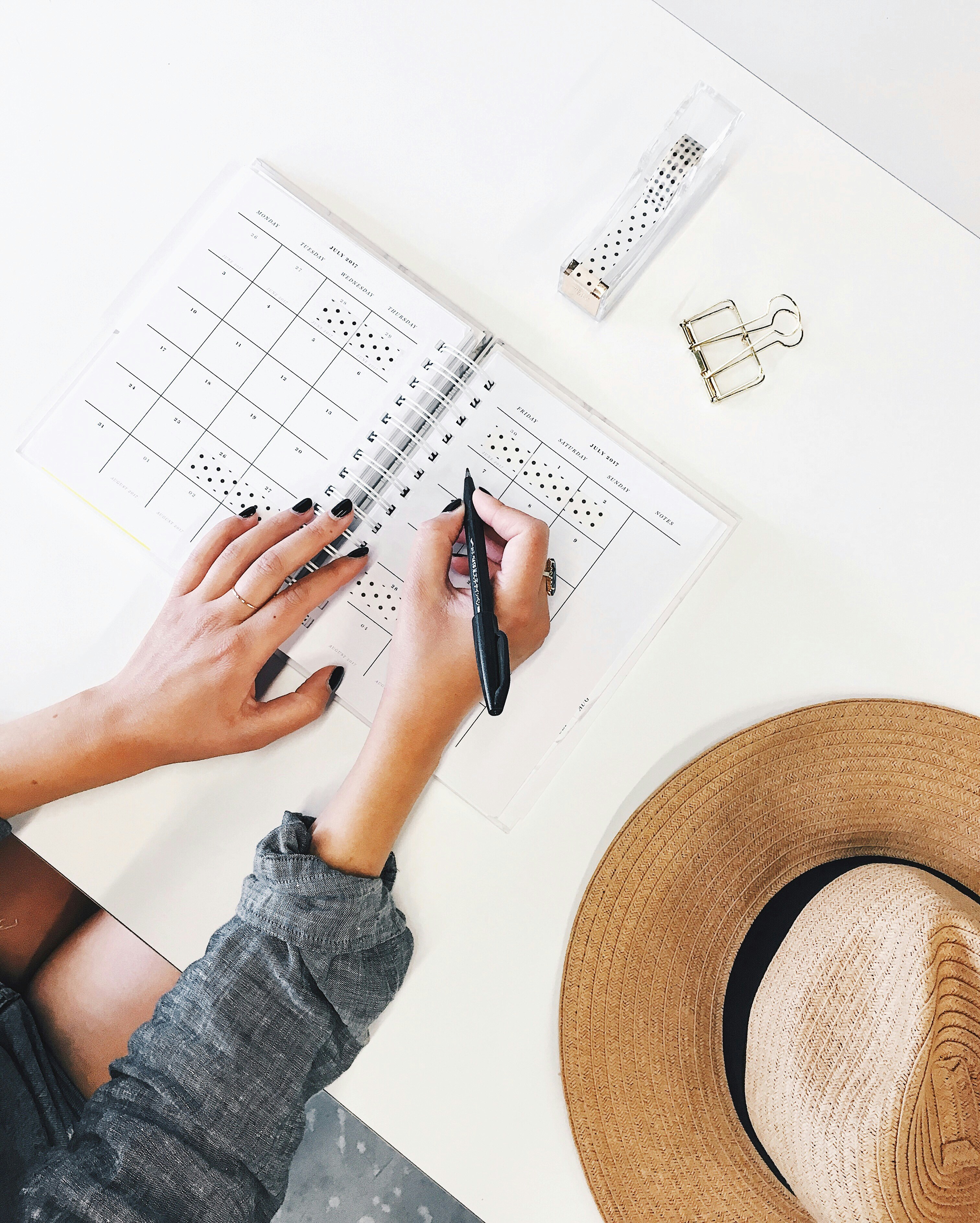 Hands organizing a planner